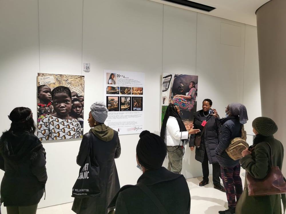 Visitors looking at photographs at an Art-Alive exhibition