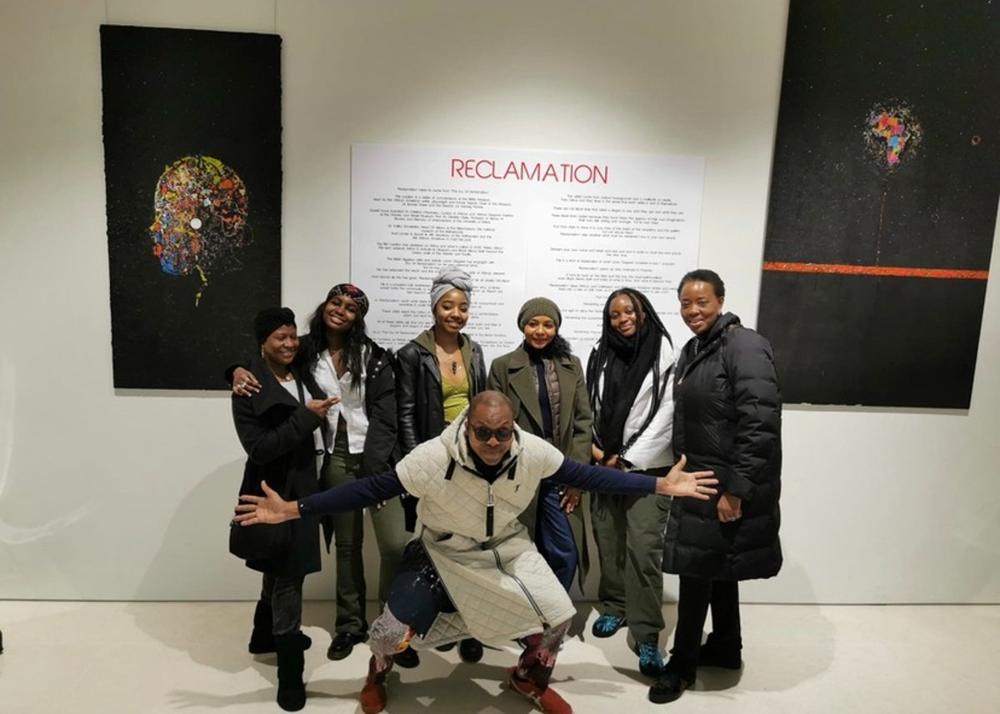 Young artists posing together at the Reclamation exhibition