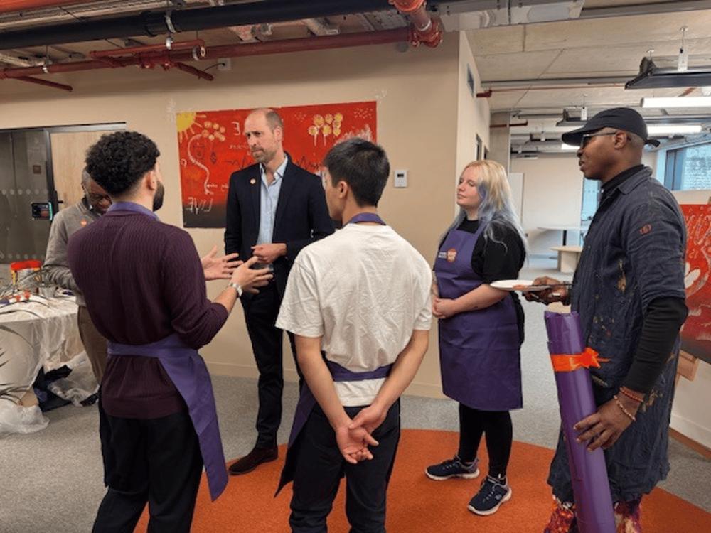 Guests in conversation with volunteers during a studio visit